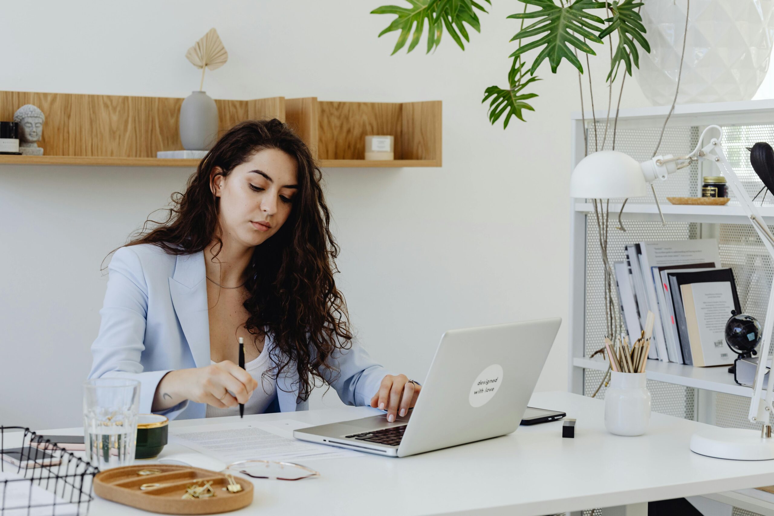 Focused person typing on laptop in clean workspace